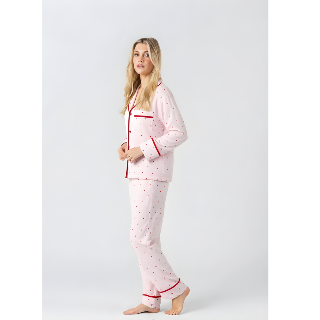 Midnight Mischief Love Heart pink long sleeve pyjama shirt and matching long pants set with red heart print and red piping, side view.