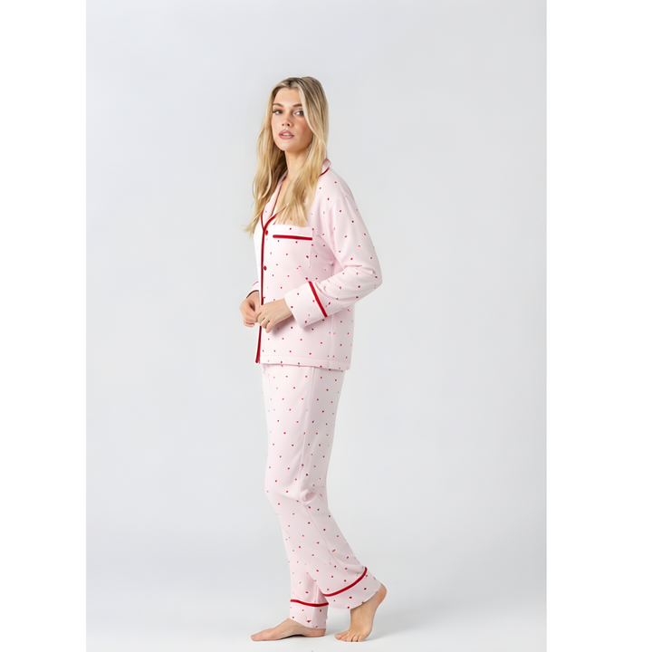 Midnight Mischief Love Heart pink long sleeve pyjama shirt and matching long pants set with red heart print and red piping, side view.